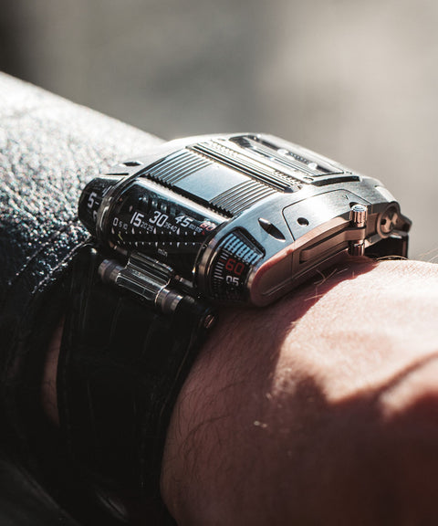 URWERK UR-111C Iron with linear time display, rotating cylinders, and steel case. Certified pre-owned, inspected by URWERK, with 3 year warranty.