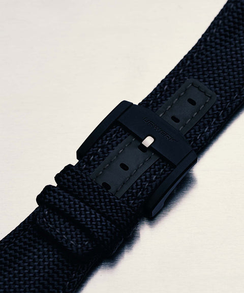 URWERK pin buckle detail showing black titanium finish.