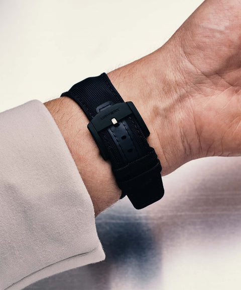 URWERK strap with black titanium pin buckle worn on wrist.