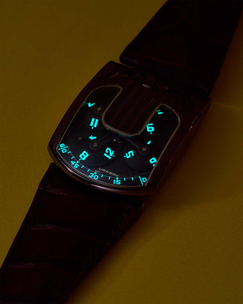 URWERK UR-103 TiAlN side profile highlighting asymmetrical case design with lume markings.