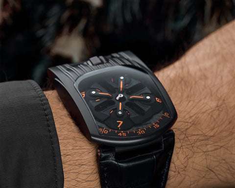 URWERK UR-103T Fireleg wrist shot showing black case and orange accents.