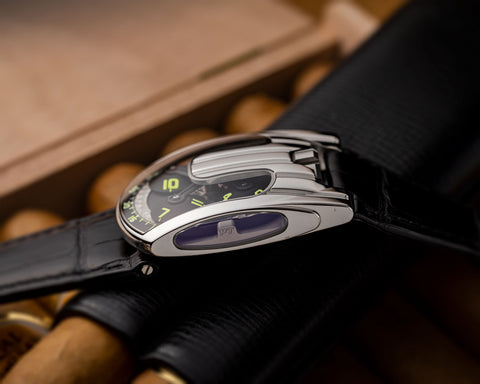 URWERK UR-103.05 platinum watch with open sapphire windows revealing satellite hour carousel.