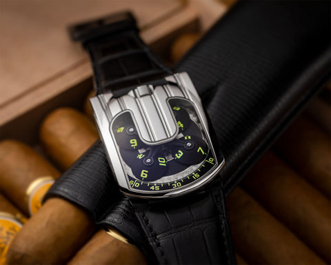 URWERK UR-103.05 platinum dial showing revolving hour satellites and black PVD titanium orbital cross.