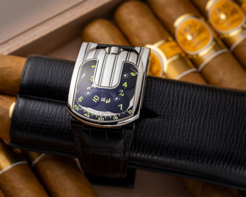 Close view of URWERK UR-103.05 satellite time display with luminous hour markers and minute arc.