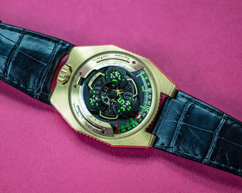 URWERK UR-100 2N gold C-3PO satellite watch with rotating hour display and domed sapphire crystal.