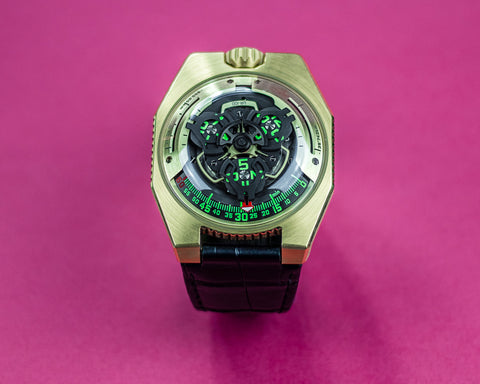 URWERK UR-100 gold wristwatch showing satellite display and pale gold case finish.