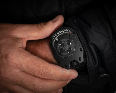 URWERK UR-105 Dark Knight dial showing rotating hour satellites beneath PEEK canopy.
