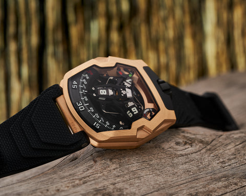  URWERK UR-210 red gold watch with satellite hour display and retrograde minute hand.