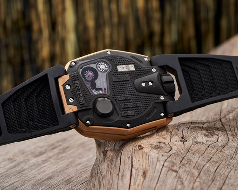 URWERK UR-210 red gold dial showing oversized retrograde minute hand and hour satellite.